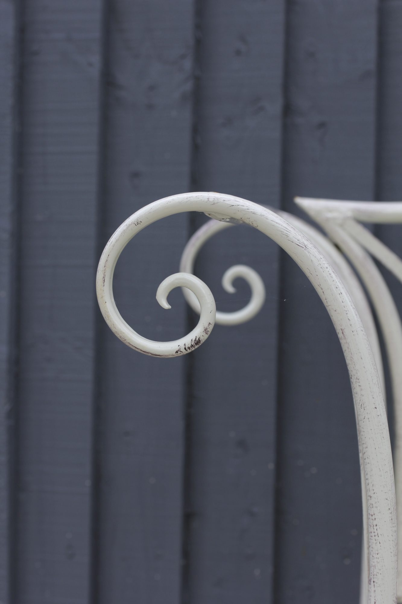 Curled edge of white metal planter