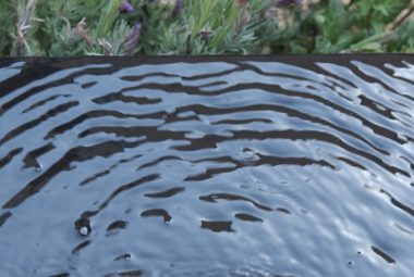 black infinity garden water feature with lavender flowers