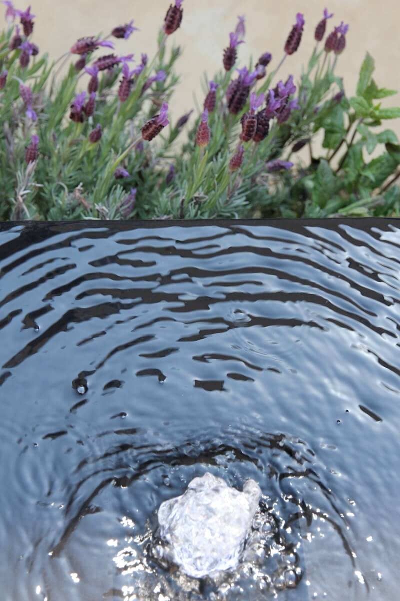 black infinity garden water feature with lavender flowers