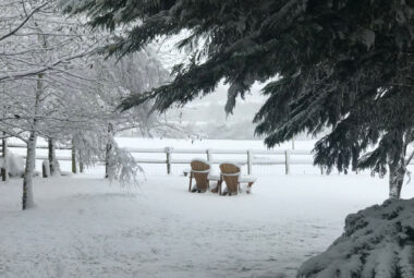 snow covered cotswold landscape with Adirondack chairs
