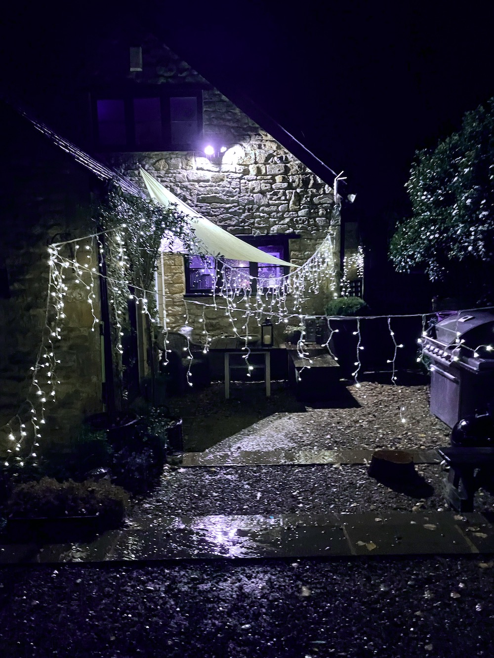 Christmas lights around cotswold home wiith very peri edit